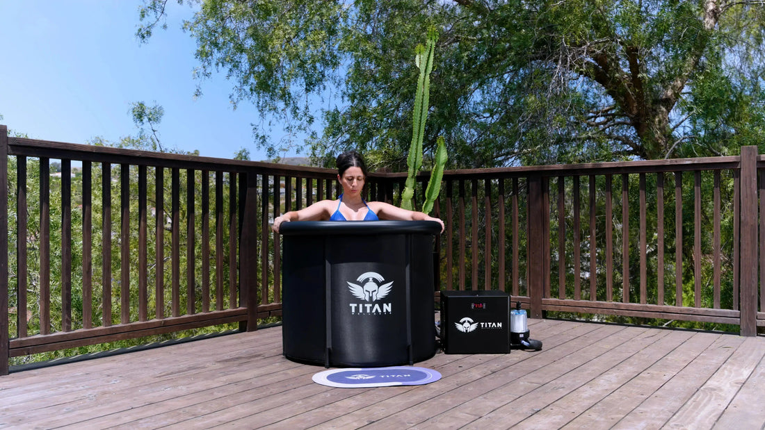 Woman in a Titan Wellness Bravo cold plunge tub with a water chiller on an outdoor wooden deck.  