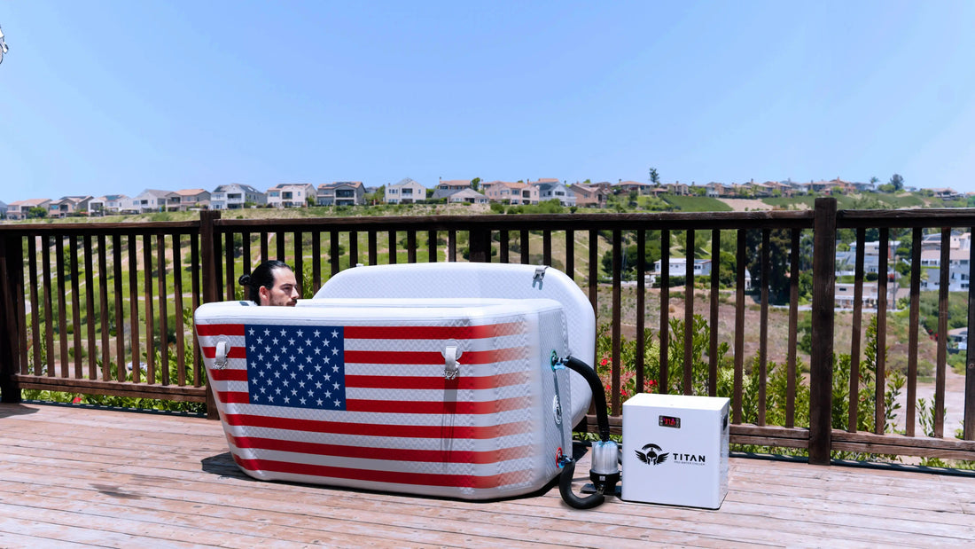 Titan Wellness Triumph cold plunge tub with water chiller on an outdoor deck overlooking a hillside, featuring the American flag design.