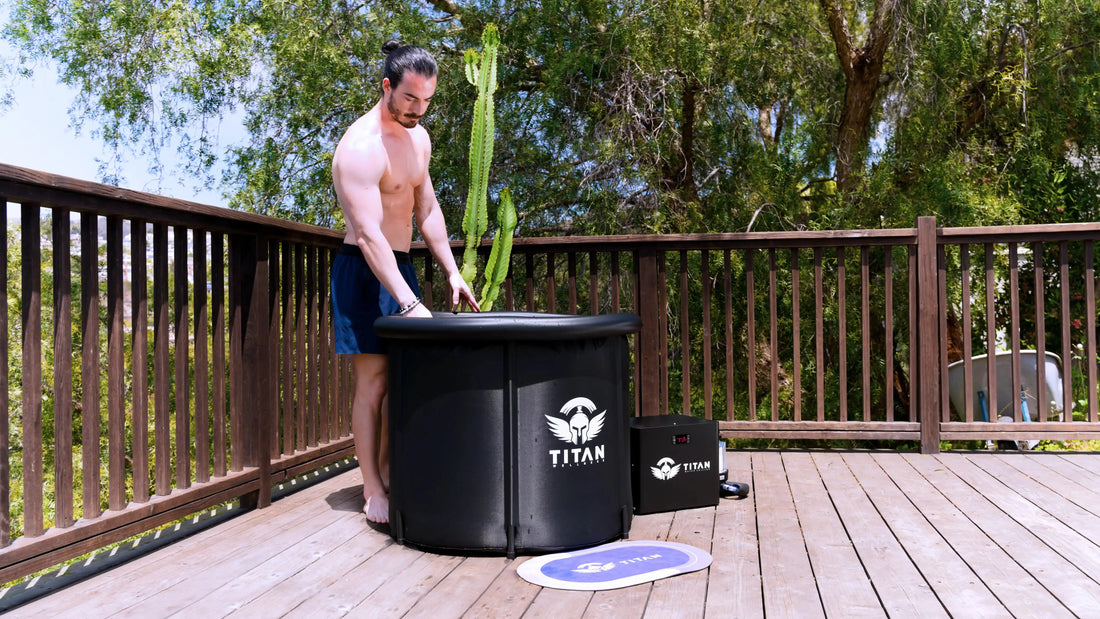 Man preparing a Titan Wellness cold plunge tub and water chiller on an outdoor wooden deck.