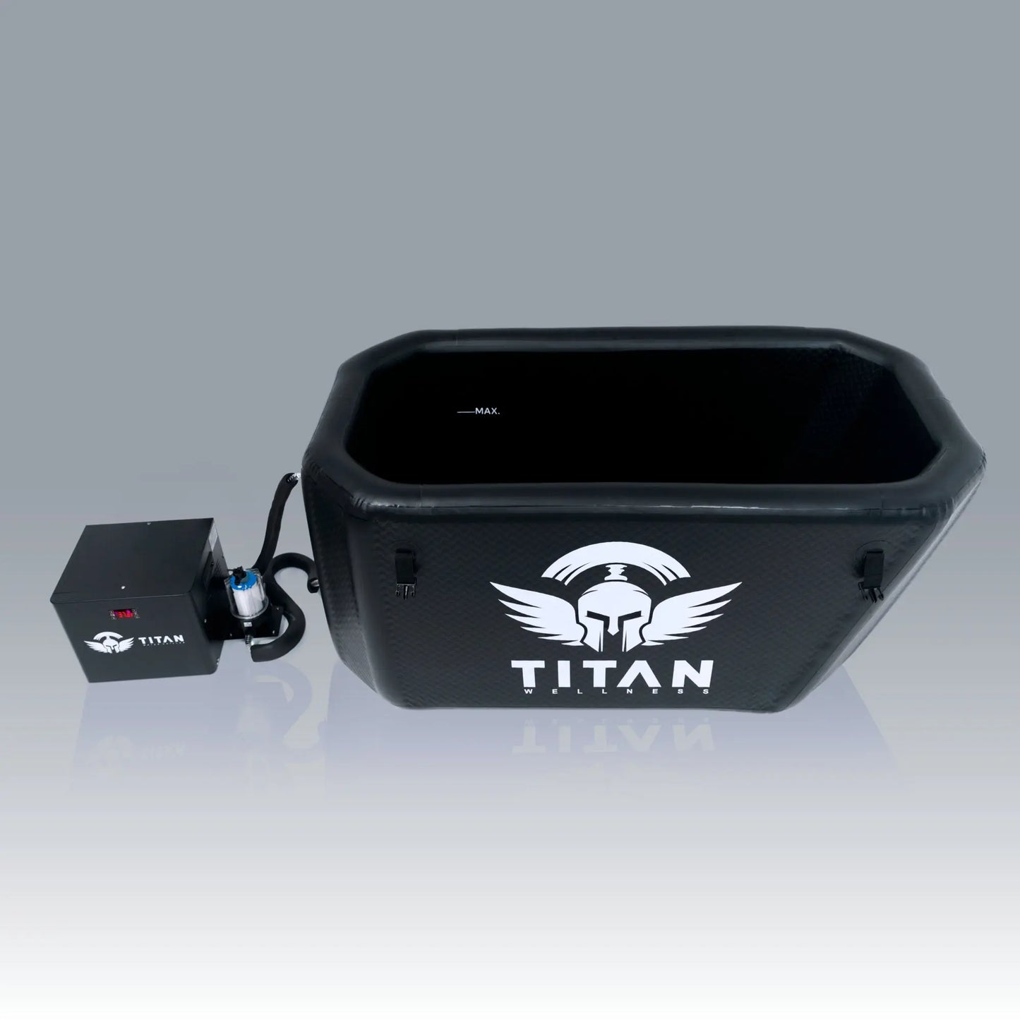  “Triumph XL cold plunge tub in black with the TITAN logo, shown from a top-down angle next to the Titan water chiller with hoses and in-line filter; interior ‘MAX’ fill line visible.”