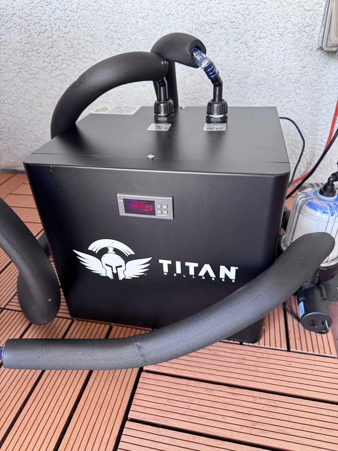 Black chiller labeled 'Titan' on a wooden deck